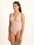 Model wearing Ocean Mystery red gingham one piece swimsuit with feminine silhouette and timeless checks.