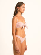 Model wearing Ocean Mystery red gingham sweetheart bikini top with knotted bow and elegant neckline.