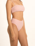 Side angle of Ocean Mystery red gingham high waist bikini bottom featuring high leg cut.