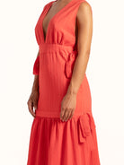 Side profile of Ocean Mystery red and mustard yellow color block maxi dress with waist tie detail.