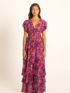 Ocean Mystery red and purple floral long dress with flutter sleeves and tiered ruffle skirt, perfect for resort wear.