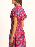 Back angle of Ocean Mystery red purple floral maxi dress featuring soft chiffon fabric and flowy silhouette.