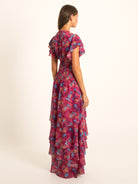 Front view of Ocean Mystery red and purple floral maxi dress with cascading ruffles and V neckline.