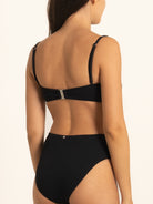Side profile of Ocean Mystery black sweetheart bikini top with wide straps.