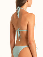 Side profile of Ocean Mystery light blue halter bikini top with adjustable fit.