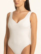 Side angle of Ocean Mystery white one piece swimsuit featuring sleek minimal cut.