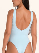 Back angle of baby blue textured one piece swimsuit with medium back coverage.