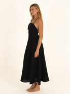 Side profile of the Onyx strappy open back linen dress, highlighting the lightweight 100% linen fabric and A-line cut.