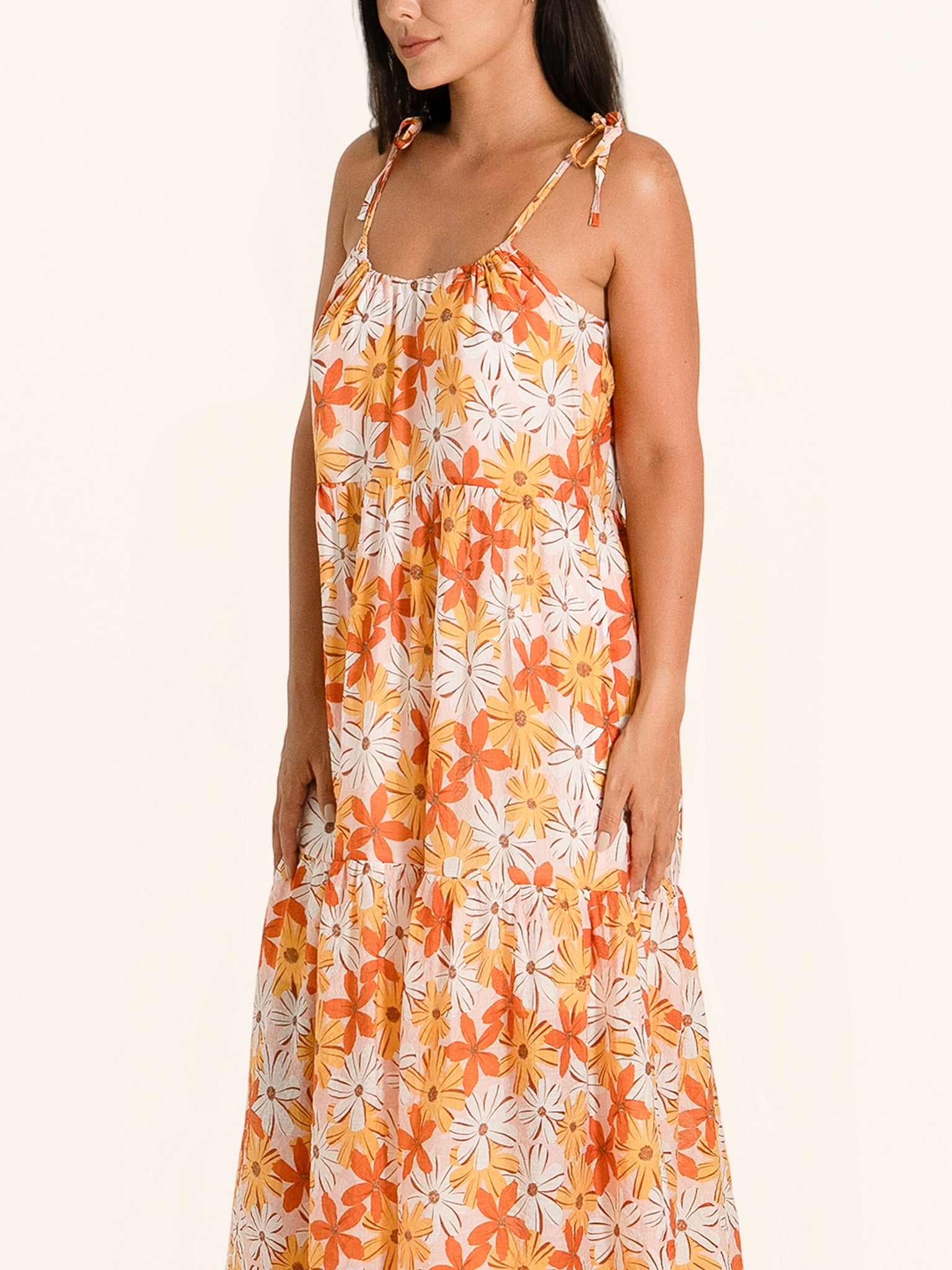 Side profile of orange floral maxi dress with relaxed fit and floral print