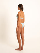 Side-back angle of pale blue bikini set highlighting fixed straps and textured fabric