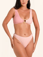 Pink bikini bottom with high waist cut and front ring detail.