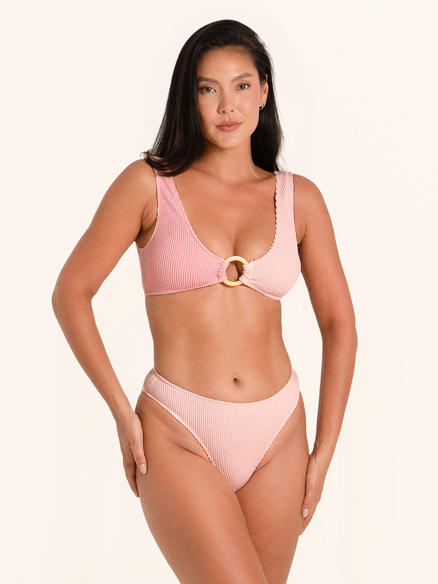 Pink bikini top with wide straps and front ring detail.