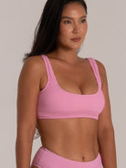 Detail of pink scoop bikini top featuring soft stretch textured fabric and supportive band