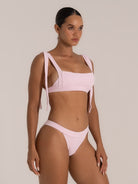 Side view of pink bikini top with sculpted square neckline and long tie shoulder straps