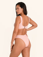 Wide strap pink bikini top with central ring style.