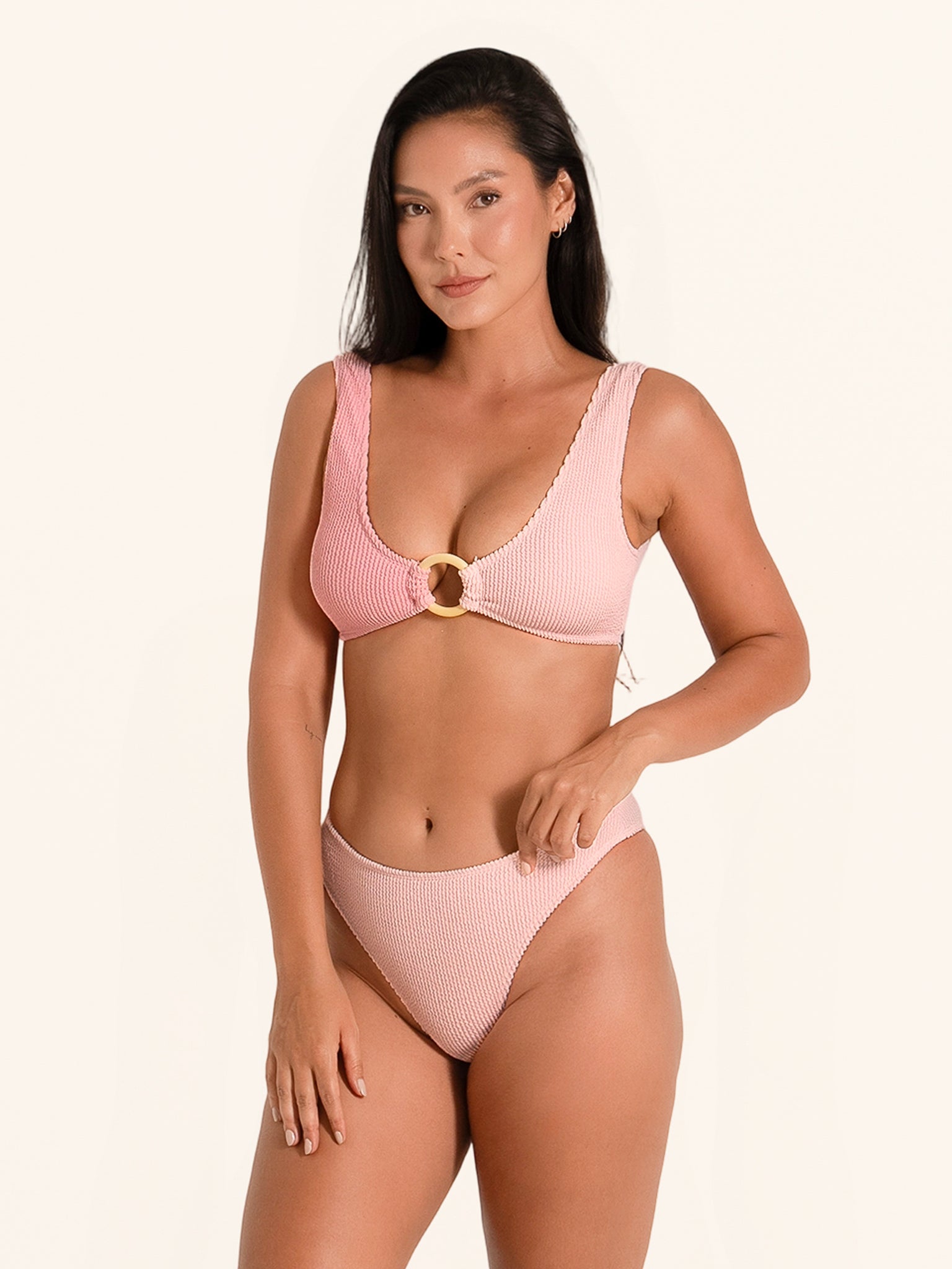 Pink high-leg bikini bottom with decorative ring detail.