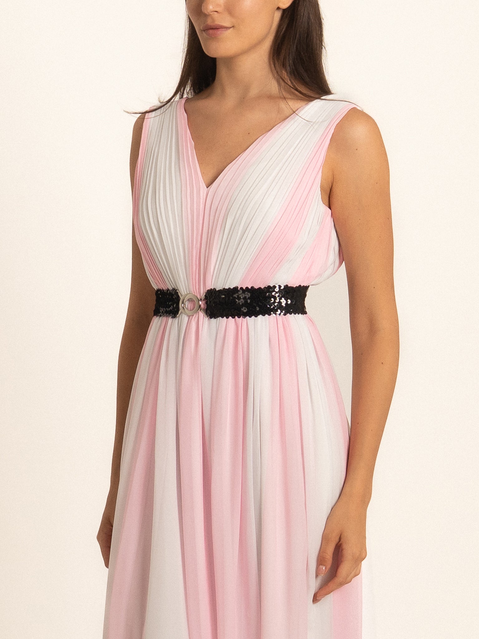Closeup front of pink maxi dress with pleated bodice and black belt