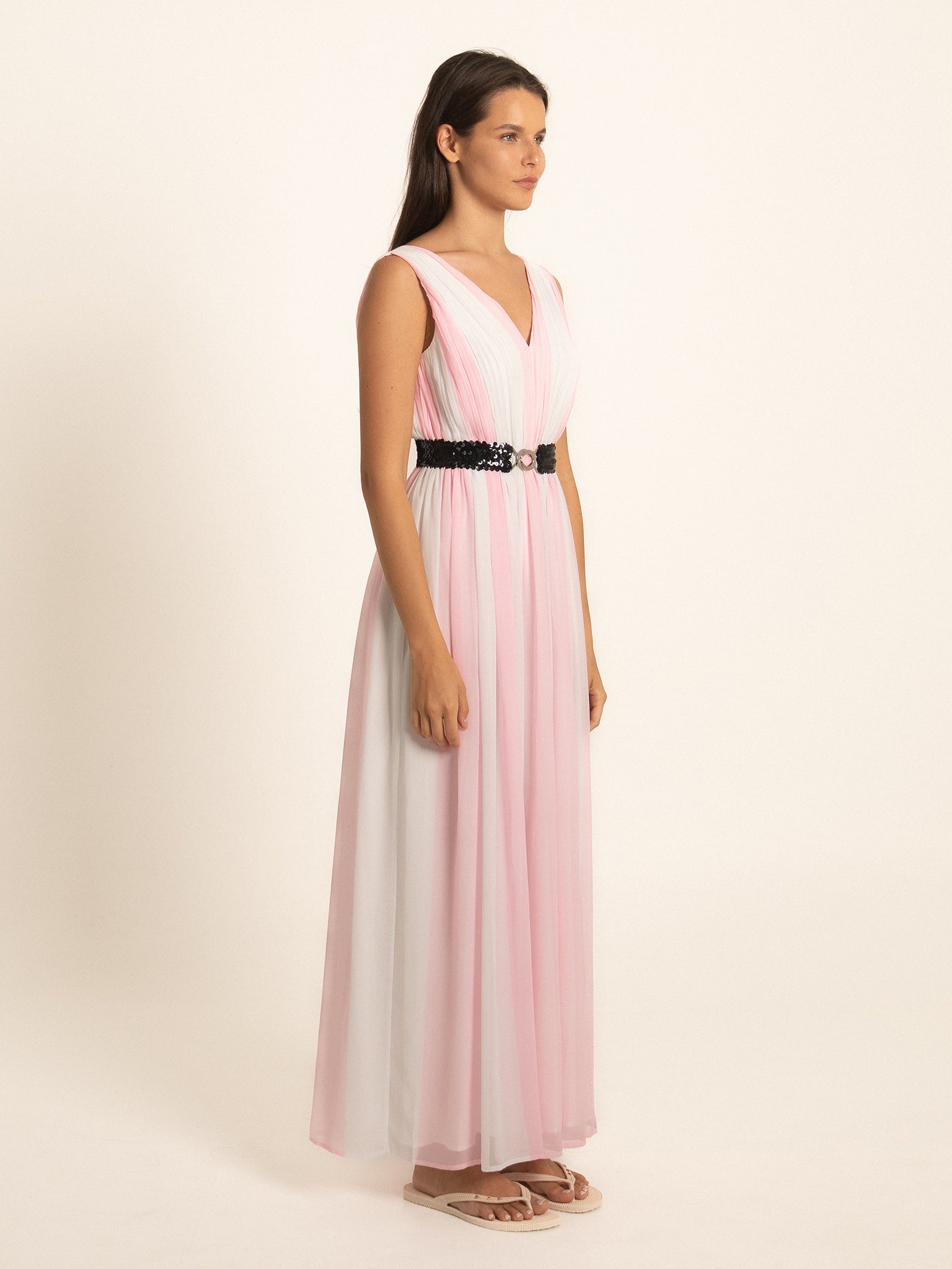 Side profile of pink maxi dress with V neckline and belted waist