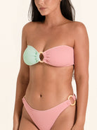 Strapless bikini top in pink and mint colorblock style with chic cut.