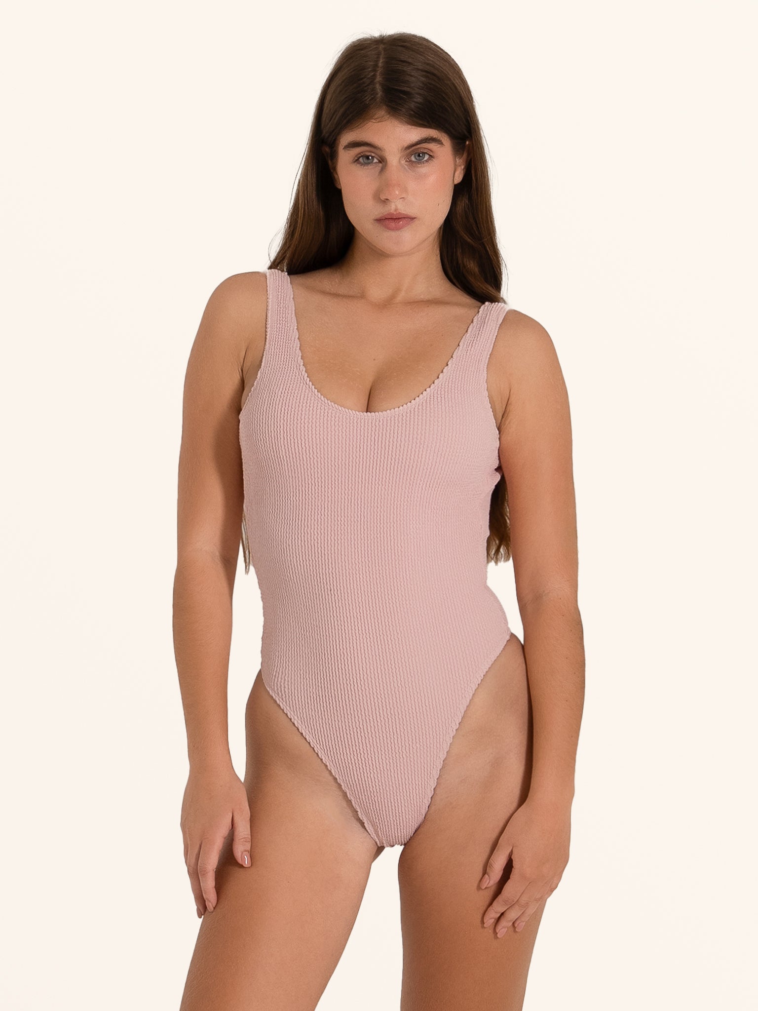 Light pink scoop neck one piece swimsuit with ribbed texture.