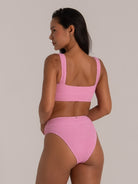 Back view of pink textured scoop neck bikini top with wide straps