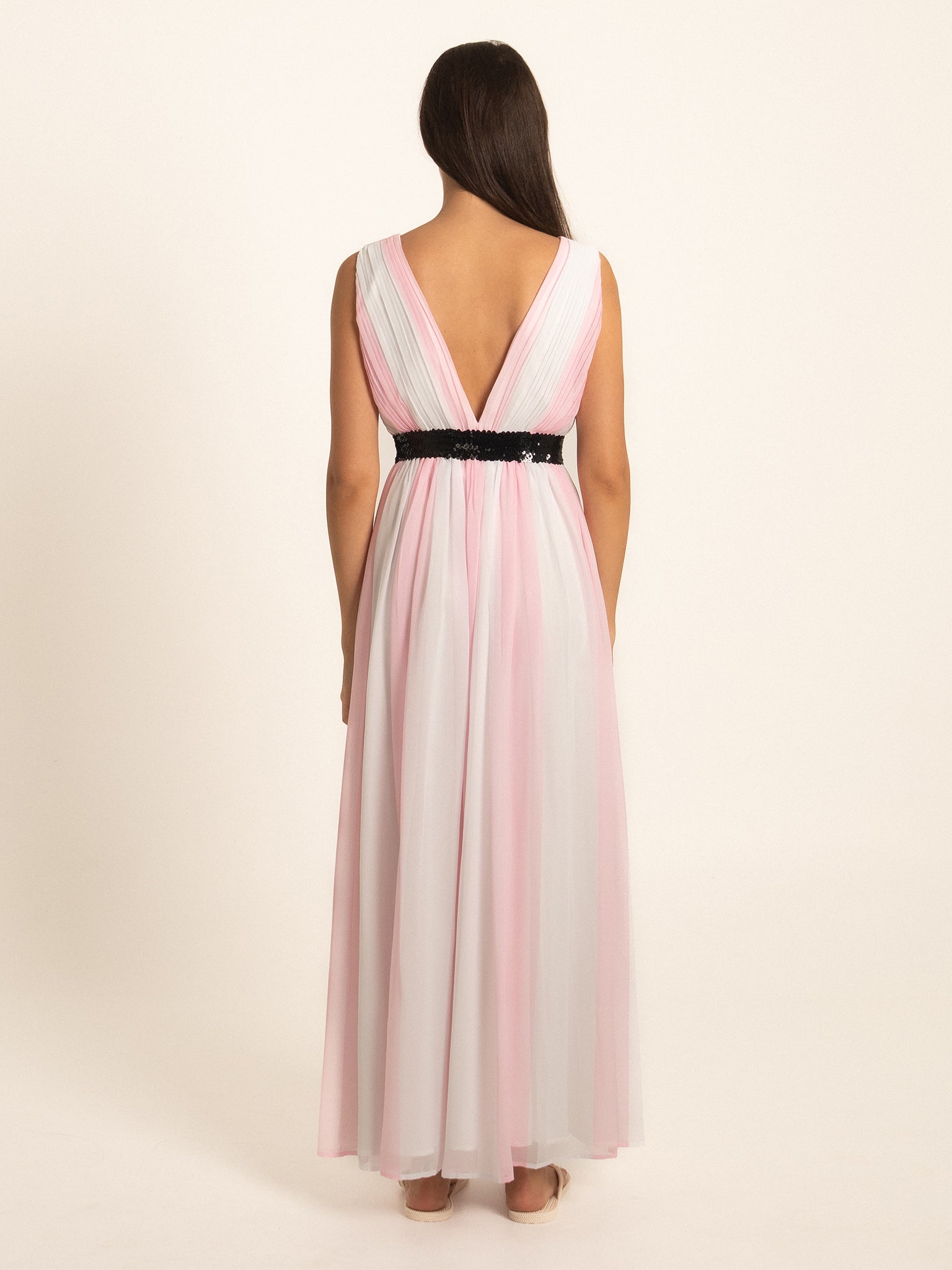 Rear full view of pink V neck maxi dress with flowing pleated skirt