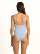 Rear view of the powder blue gingham high-cut one-piece, emphasizing the flawless, dig-free contouring along the hips and back.