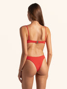 Over shoulder look at red bikini bottom showing chic and bold fit.