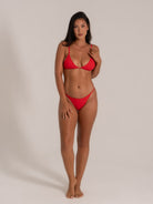 Front view of red triangle bikini set featuring plunge neckline and high leg cut.
