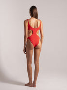 Back view of red one-piece swimsuit with side cutouts