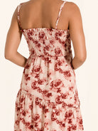 Back view of red floral maxi dress with ruched bodice and relaxed fit