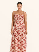 Front view of red floral maxi dress with spaghetti straps and ruched bodice