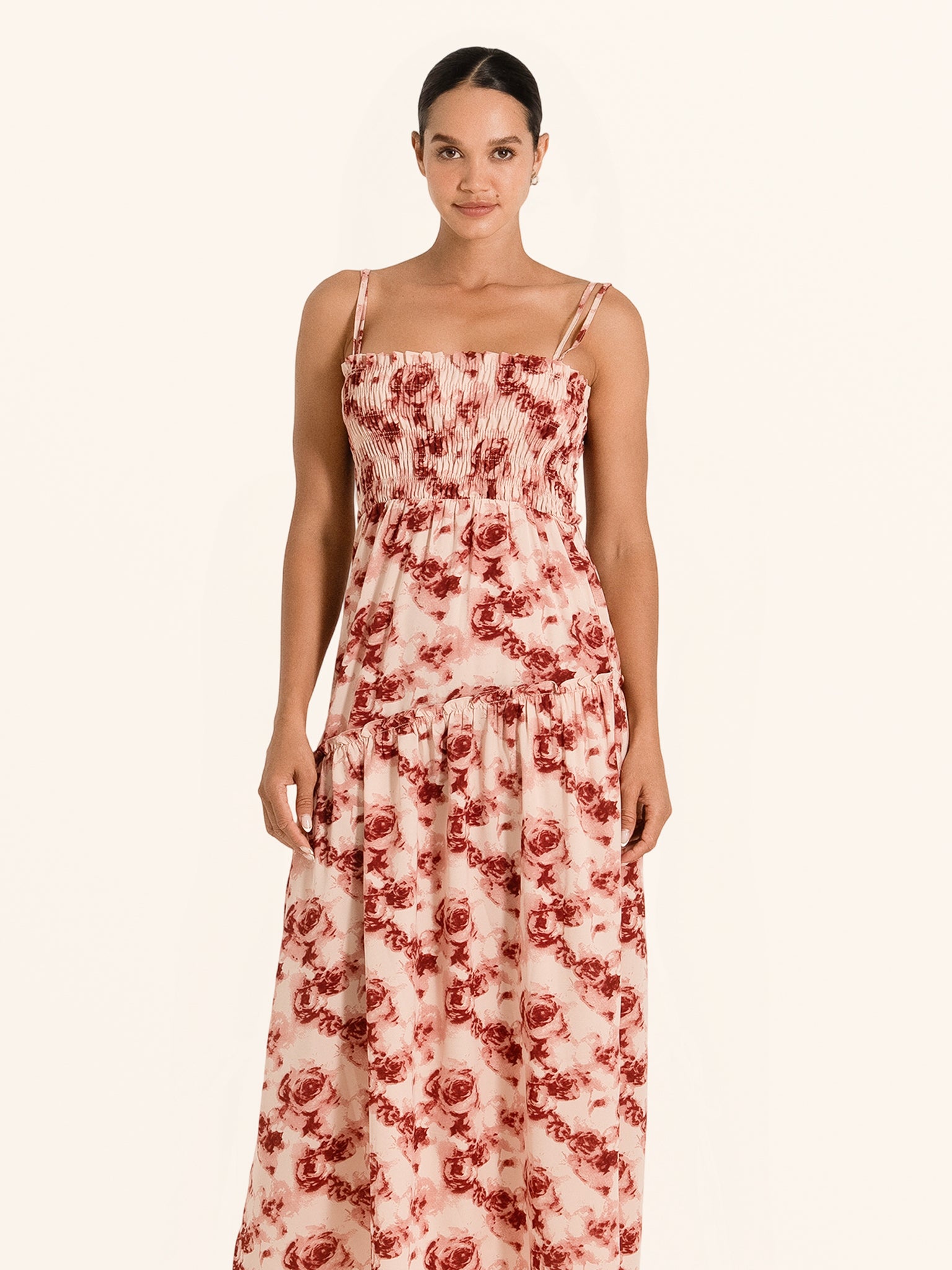 Front view of red floral maxi dress with spaghetti straps and ruched bodice