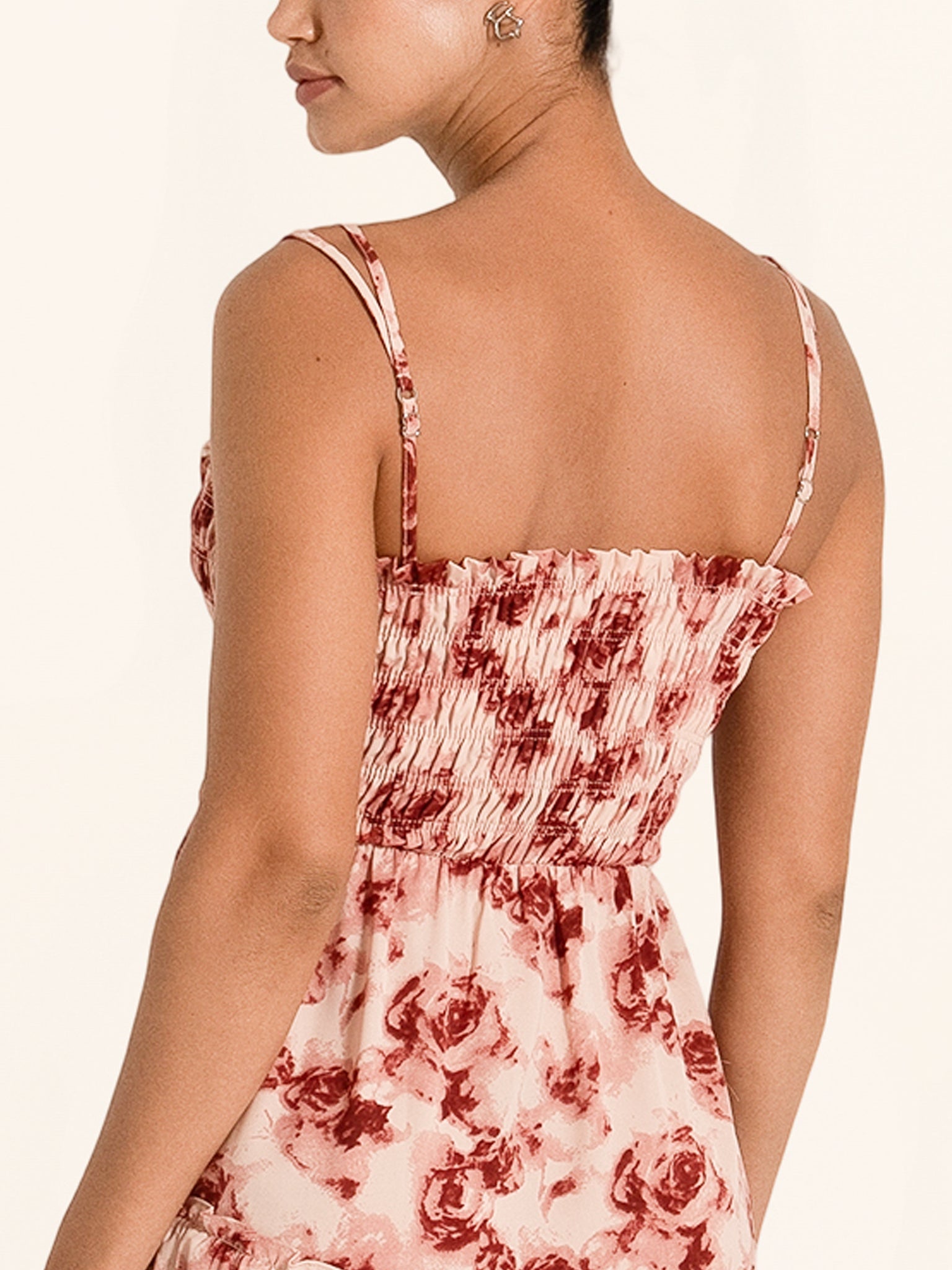 Side profile of red floral maxi dress with adjustable straps and flowy skirt