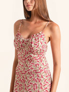 Side profile of red floral spaghetti strap dress with flowy hemline
