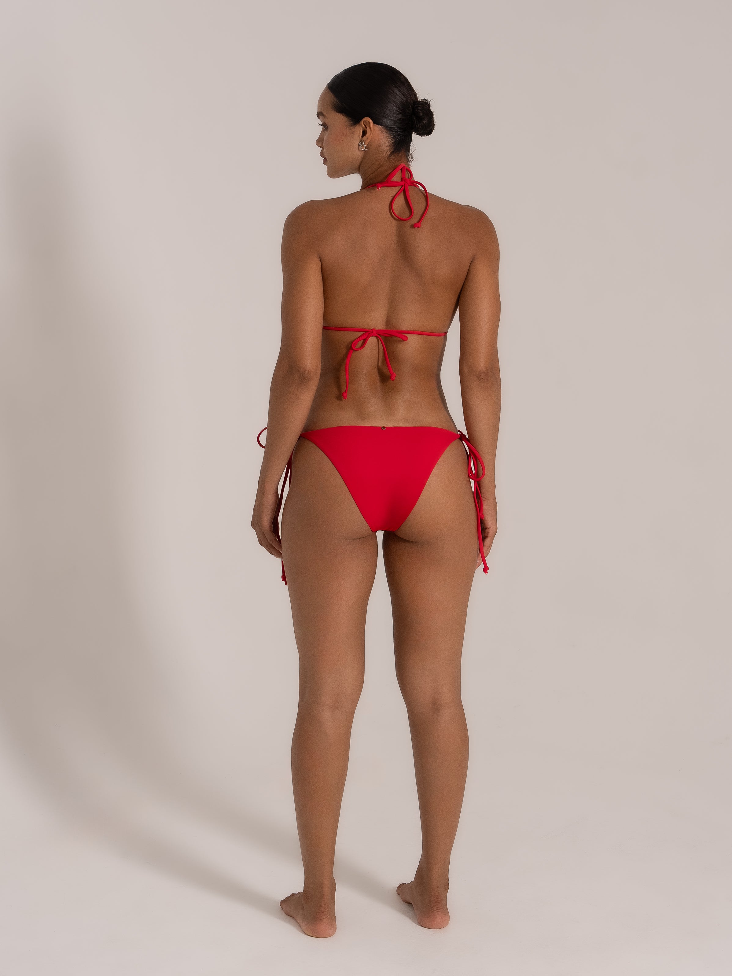 Back view of model wearing red halter triangle bikini set from OCEAN MYSTERY