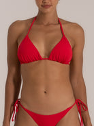 Close-up front view of a red halter neck triangle bikini top with matching tie-side bikini bottom.