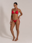 Angled front view of red tie-side triangle bikini set from OCEAN MYSTERY