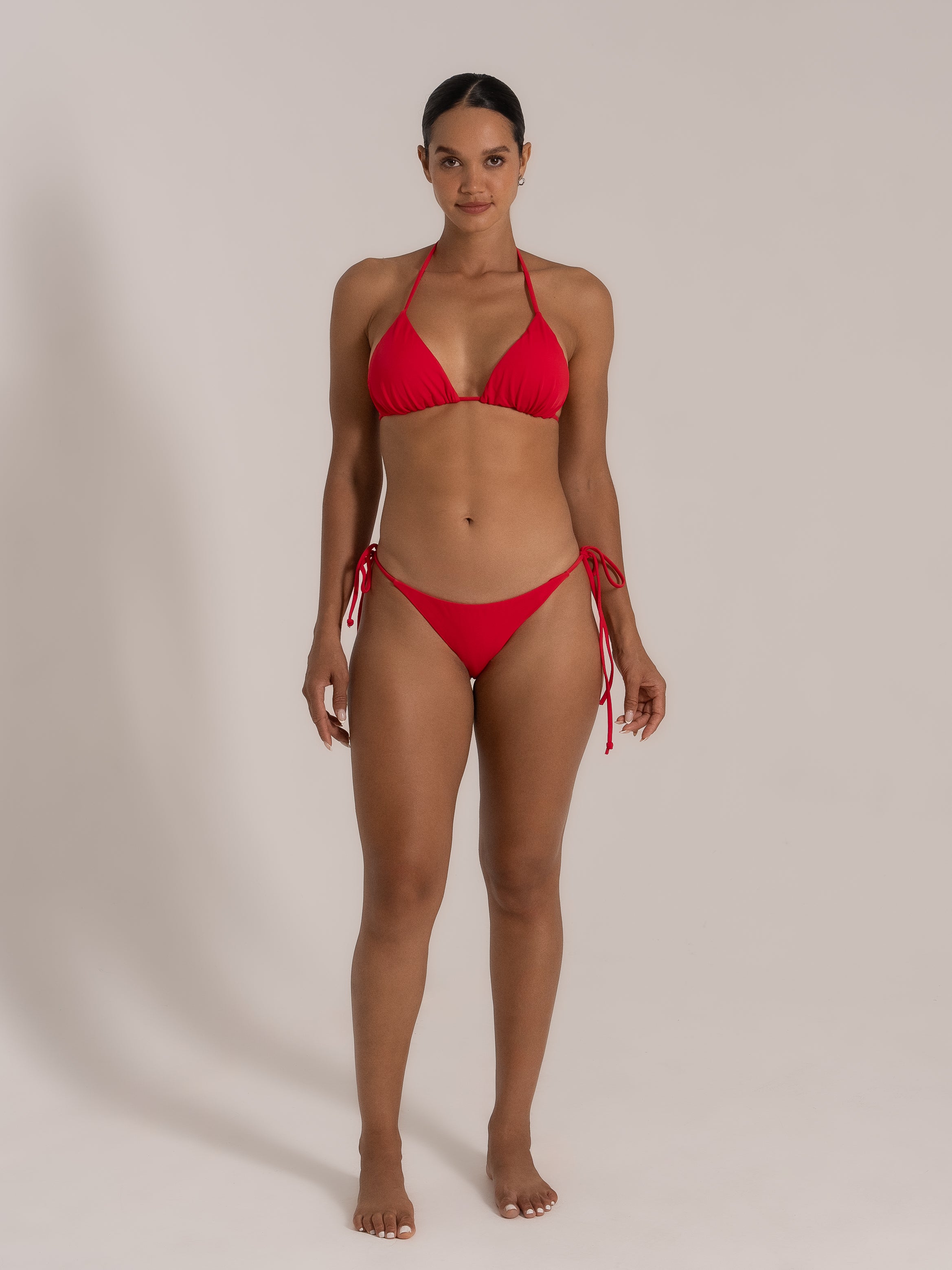 Front view of model in red triangle bikini set with halter neck from OCEAN MYSTERY