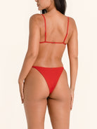 Red bikini bottom in a minimal coverage fit for a sleek silhouette.