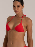 Front close-up of red string bikini top with soft cups and textured fabric
