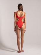 Back view of red textured one-piece swimsuit with cutouts