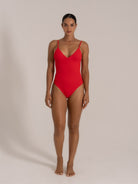 Front view of red textured one-piece swimsuit with a V neckline and a flattering fit.