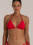 Close-up of red triangle swim top featuring adjustable halter neckline