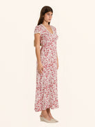 Side profile of red and white floral midi dress with flowy hemline