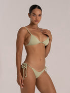 Side angle of textured green bikini top with soft cups and spaghetti straps