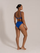 Side-back view of royal blue textured bikini set with wide waistband and soft stretch fit.