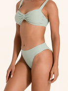 Ribbed light green bikini bottom with modern high cut design.