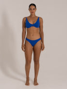 Front view of model in royal blue bikini set with scoop neck top and classic cut bottoms.