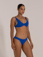 Woman modeling royal blue underwire bikini from the side, highlighting fit and shape